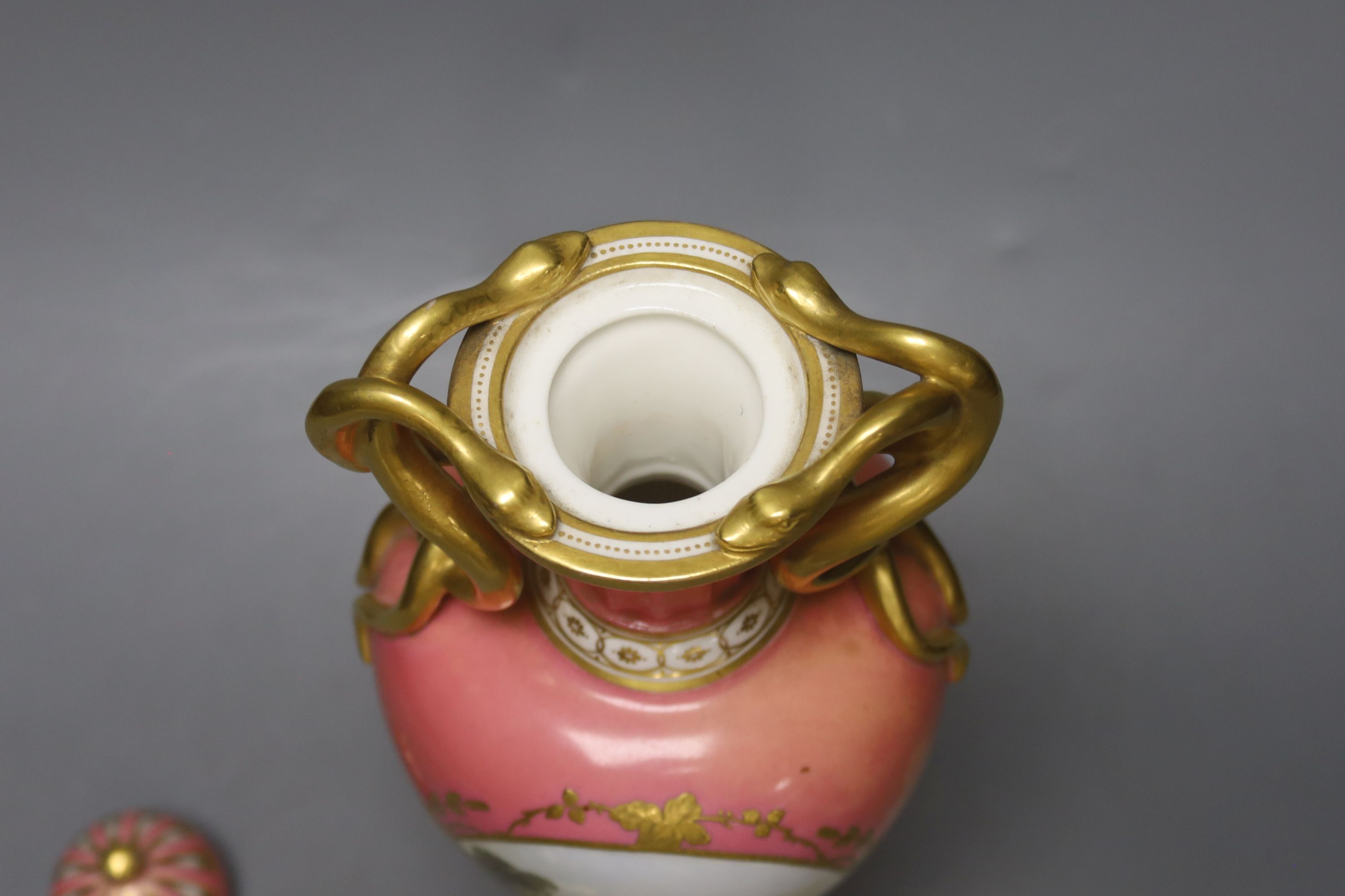 A Coalport pink ground vase and cover, with serpent handle painted with a landscape c.1825, height 29cm